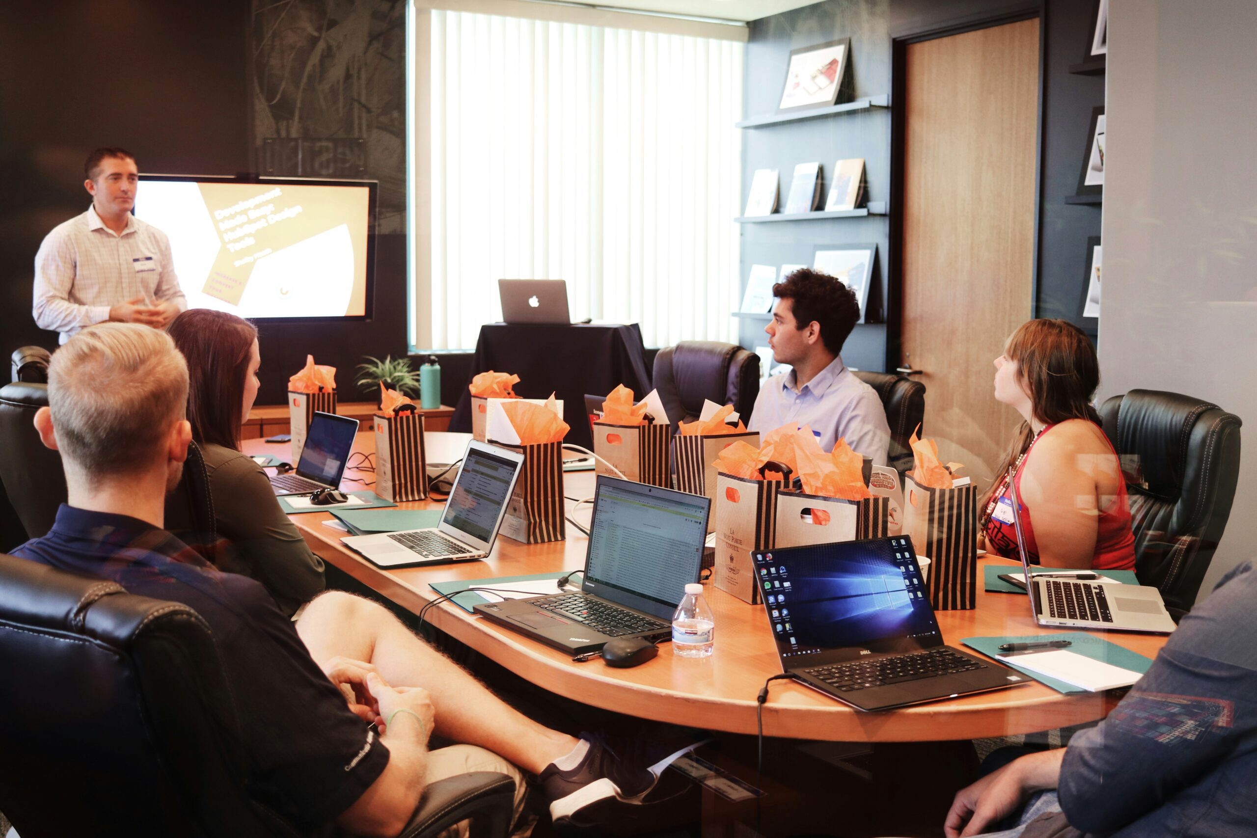 A business leader presenting strategic HR growth plans to a professional team in a conference room.